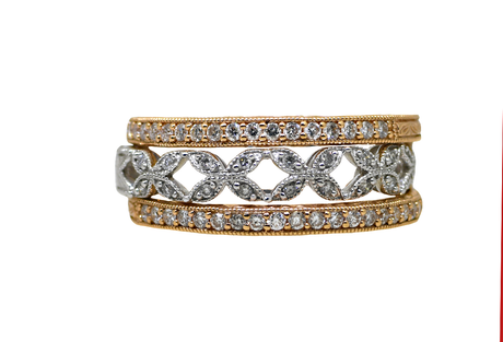 Set of three diamond-studded rings on a white background