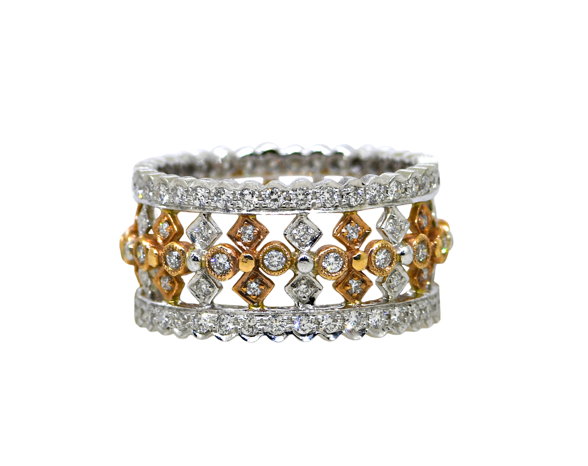 Stack of gold and silver rings with diamond accents on a white background