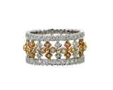 Stack of gold and silver rings with diamond accents on a white background