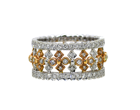 Stack of gold and silver rings with diamond accents on a white background