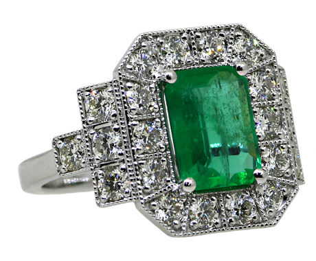 Emerald and diamond ring on a white background